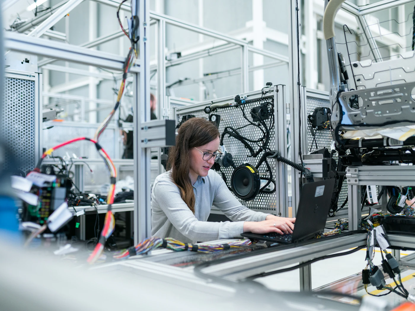 An engineer working at a technical workstation surrounded by instrumentation.